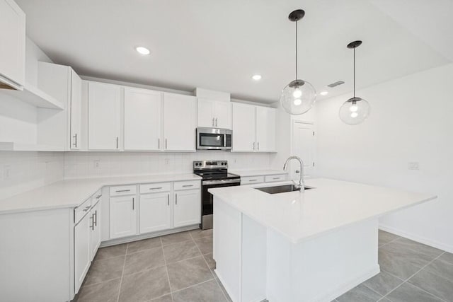 kitchen featuring decorative backsplash, white cabinetry, stainless steel appliances, and a sink