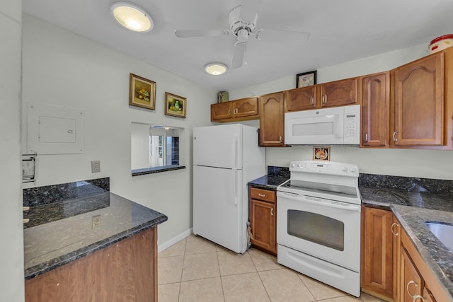 kitchen with ceiling fan, white appliances, dark stone countertops, and light tile patterned floors