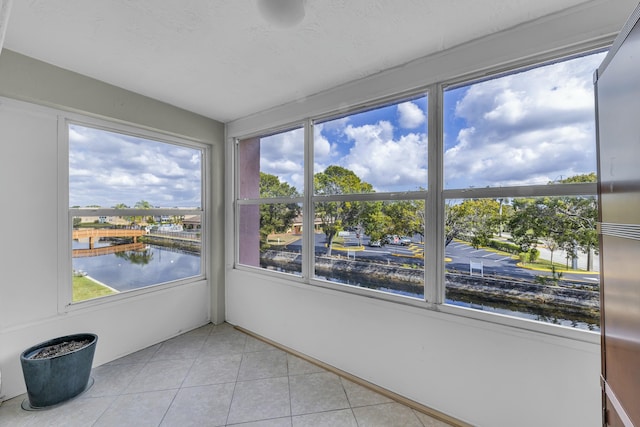 unfurnished sunroom with a water view