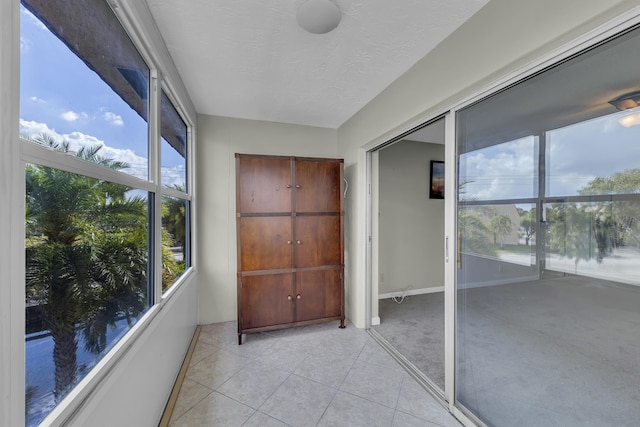 unfurnished sunroom with a water view