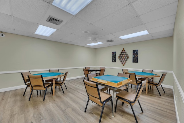 game room featuring light hardwood / wood-style flooring and a drop ceiling