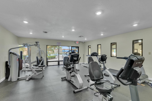 workout area featuring a textured ceiling