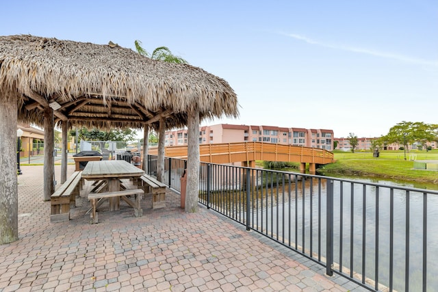 view of patio featuring a gazebo, a water view, and area for grilling