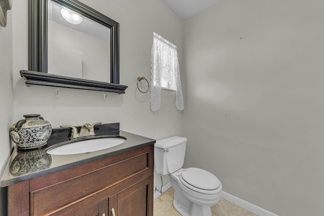 bathroom featuring vanity, tile patterned floors, and toilet