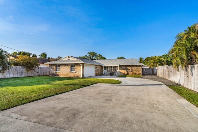 single story home with a garage and a front lawn