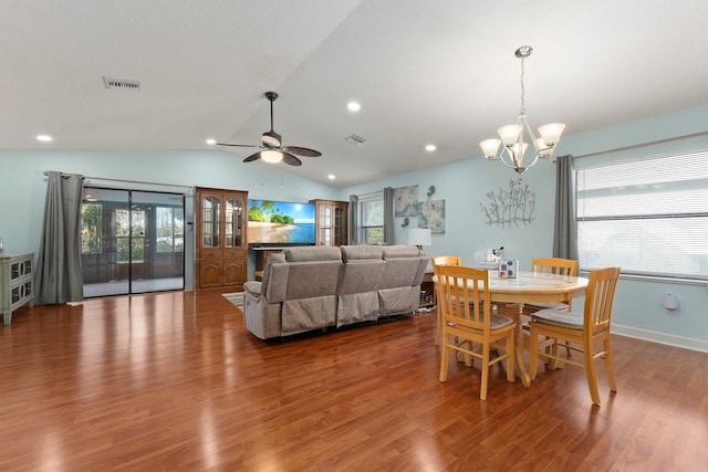 dining space with ceiling fan with notable chandelier, lofted ceiling, and hardwood / wood-style floors