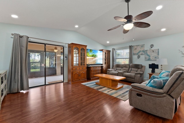 living room featuring dark hardwood / wood-style flooring, vaulted ceiling, and ceiling fan