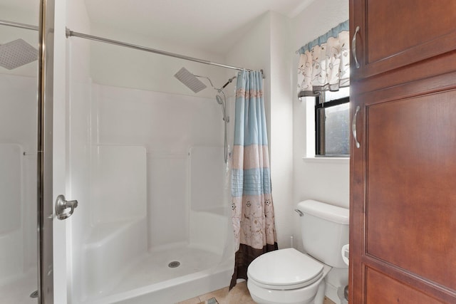 bathroom featuring toilet and a shower with shower curtain