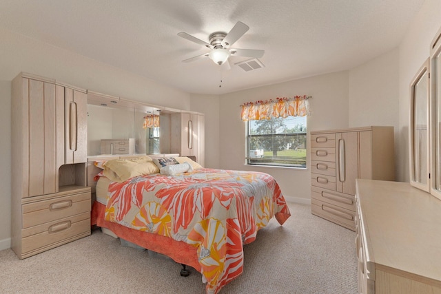 bedroom with ceiling fan and light colored carpet