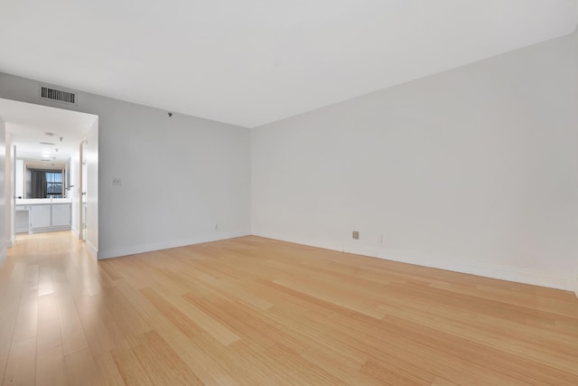 unfurnished room with light wood-type flooring