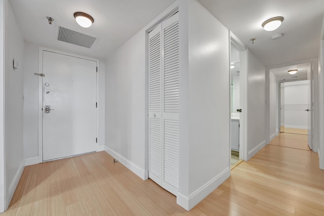 corridor featuring light hardwood / wood-style floors