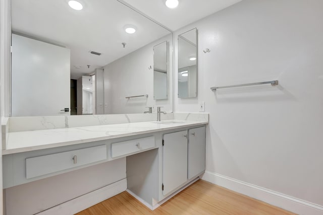 bathroom with vanity and hardwood / wood-style floors