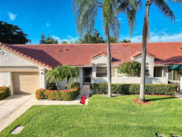 view of front of property featuring a garage and a front yard