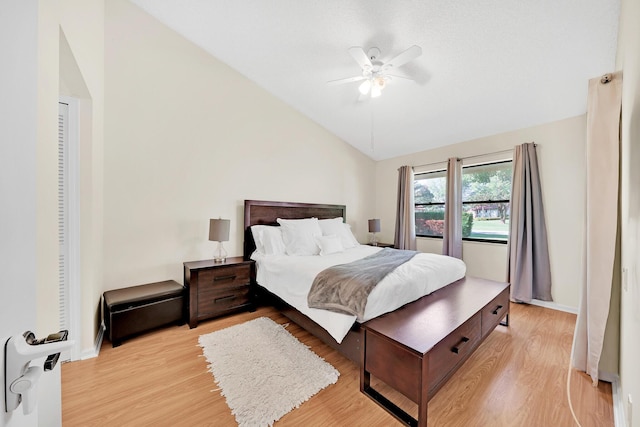 bedroom with vaulted ceiling, ceiling fan, and light hardwood / wood-style floors