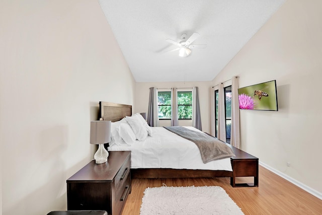 bedroom with vaulted ceiling, light hardwood / wood-style floors, and ceiling fan