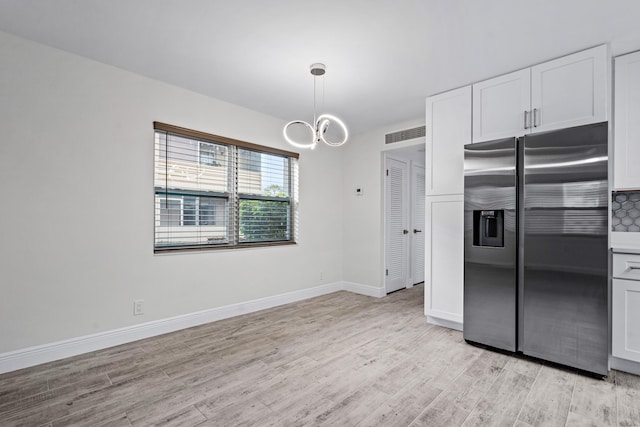 kitchen featuring white cabinetry, light hardwood / wood-style floors, and stainless steel fridge with ice dispenser