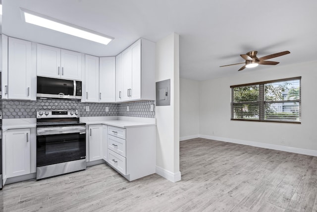 kitchen featuring white cabinetry, backsplash, and stainless steel appliances