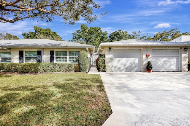 single story home featuring a garage and a front lawn