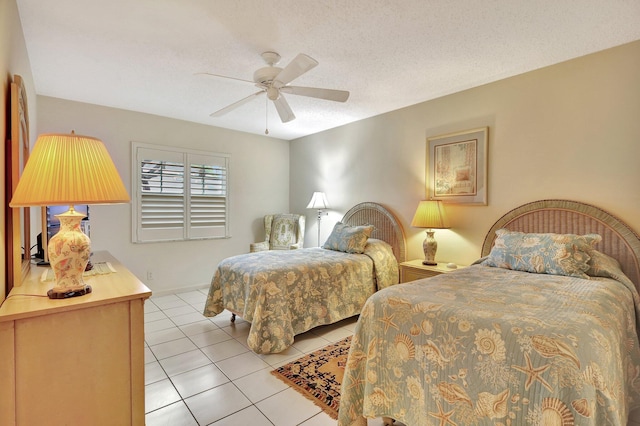 bedroom with light tile patterned flooring, ceiling fan, and a textured ceiling