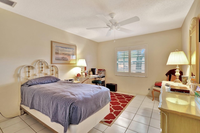 bedroom with ceiling fan, a textured ceiling, and light tile patterned flooring