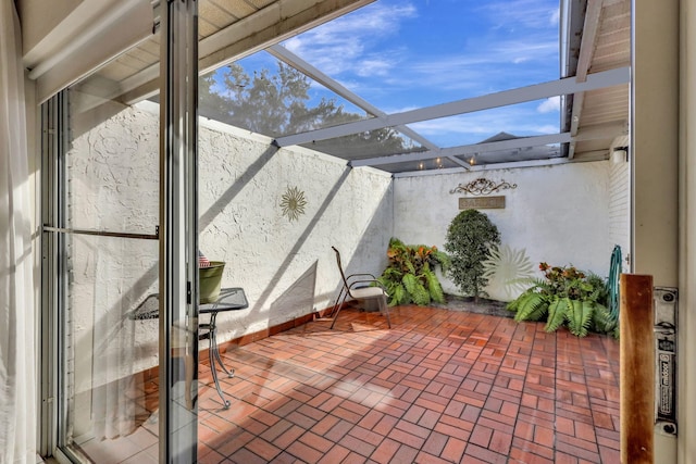 view of patio / terrace featuring a lanai