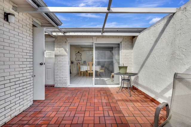 view of patio / terrace featuring a lanai