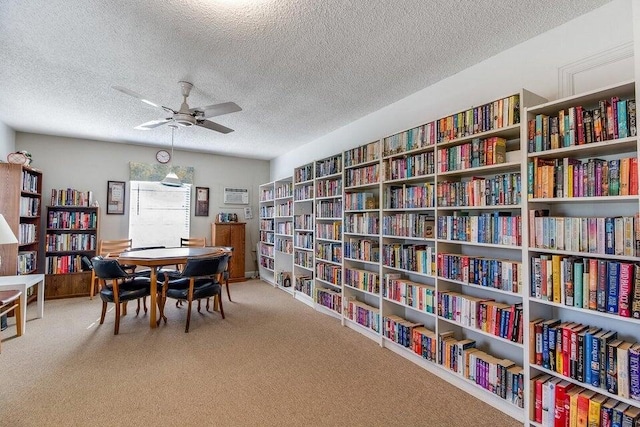 interior space with ceiling fan and a textured ceiling