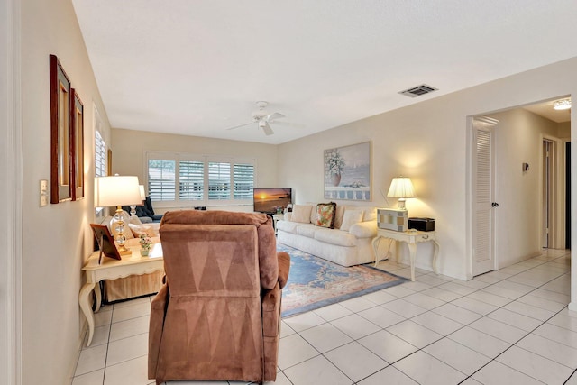 tiled living room with ceiling fan