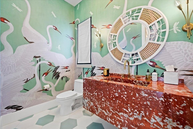 bathroom with tile patterned flooring, sink, and toilet