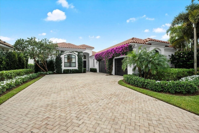 mediterranean / spanish house with a garage