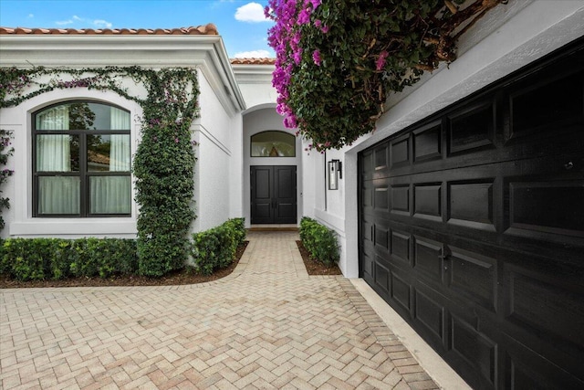 view of exterior entry with a garage