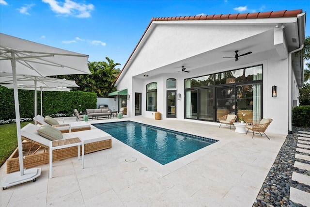 view of swimming pool with ceiling fan, an outdoor hangout area, and a patio