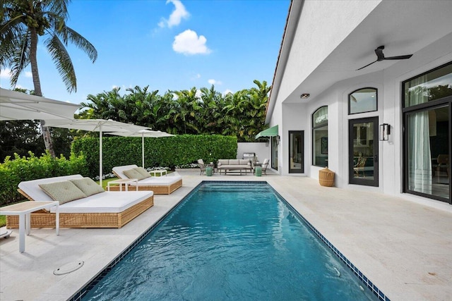 view of swimming pool featuring an outdoor living space, a patio, and ceiling fan