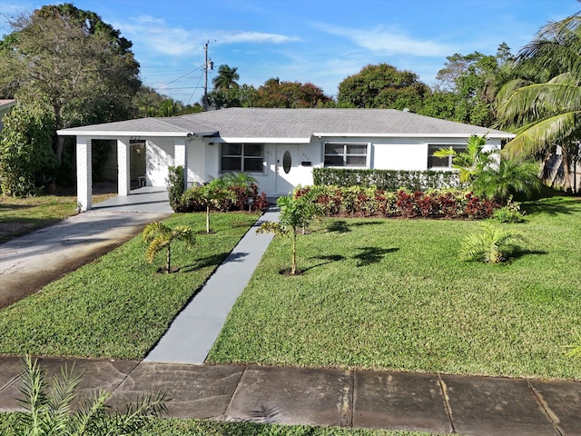 ranch-style home with a carport and a front lawn