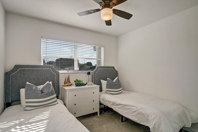 bedroom featuring dark carpet and ceiling fan