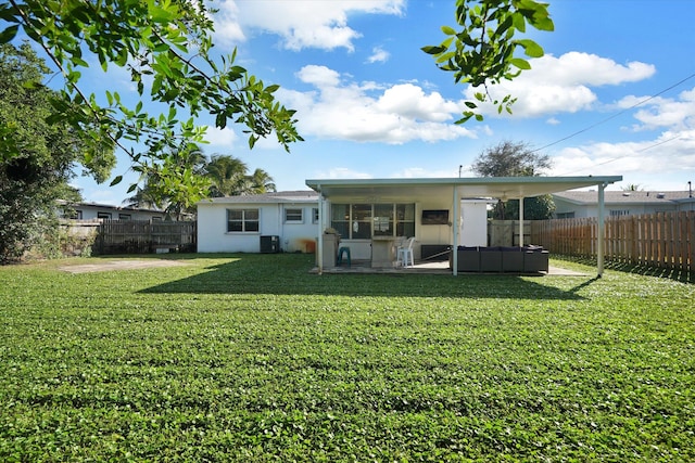 back of house featuring a yard, a patio area, and central air condition unit