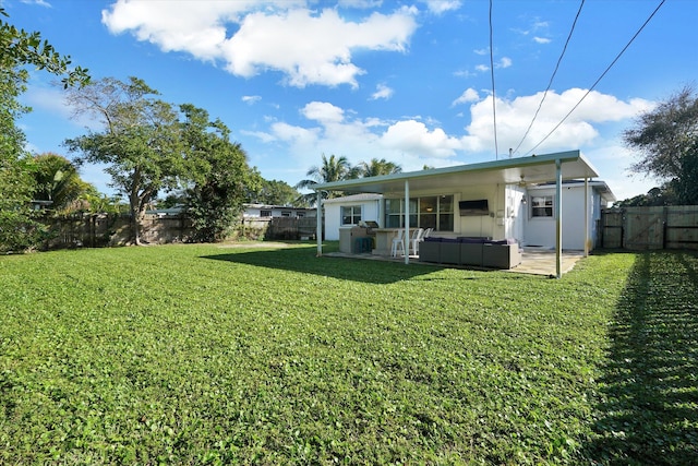 rear view of house with a lawn, outdoor lounge area, and a patio