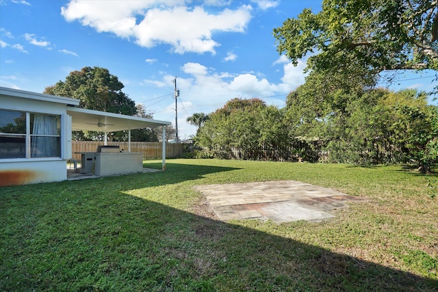 view of yard with a patio, area for grilling, and ceiling fan