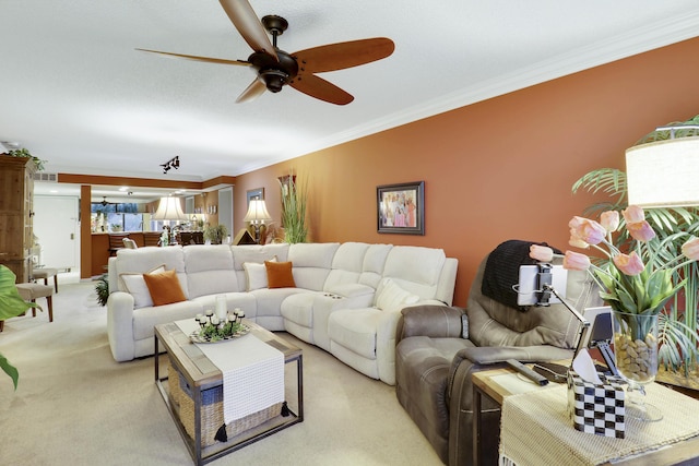 living room featuring crown molding, light colored carpet, and ceiling fan