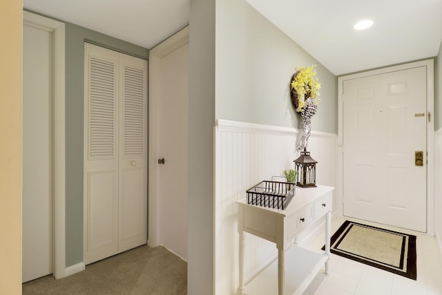 entryway with light colored carpet