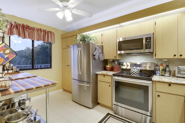 kitchen with tasteful backsplash, appliances with stainless steel finishes, light brown cabinets, and ceiling fan