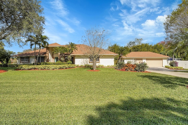 single story home with a garage and a front lawn