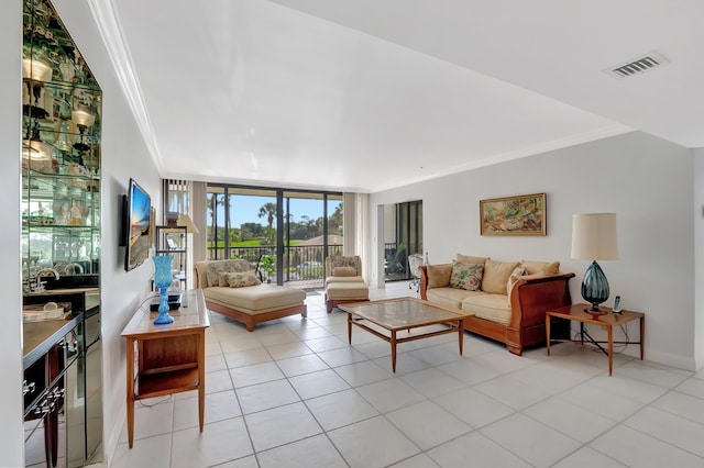 tiled living room featuring ornamental molding and floor to ceiling windows