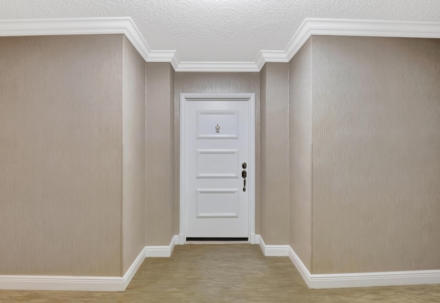 hall featuring crown molding and a textured ceiling