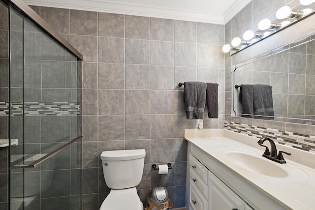 bathroom featuring toilet, an enclosed shower, crown molding, tile walls, and vanity