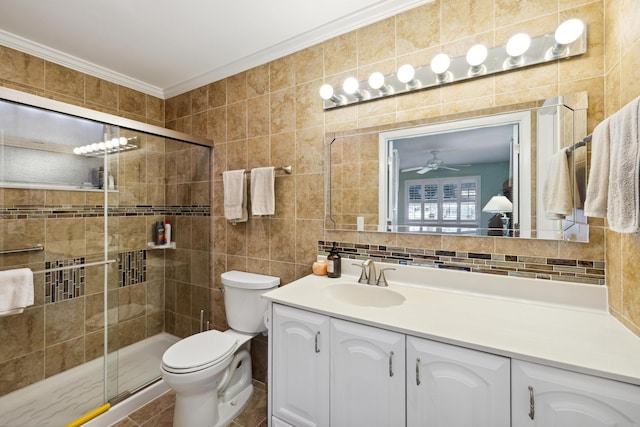 bathroom with tile walls, vanity, ornamental molding, toilet, and walk in shower