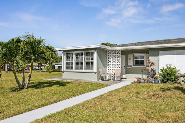 rear view of property with a lawn