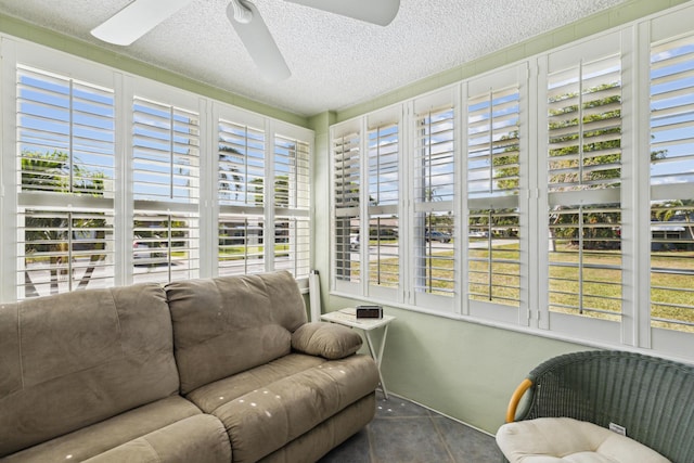 sunroom / solarium featuring ceiling fan