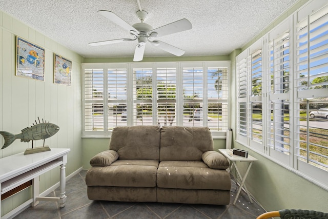 sunroom / solarium featuring a healthy amount of sunlight and ceiling fan