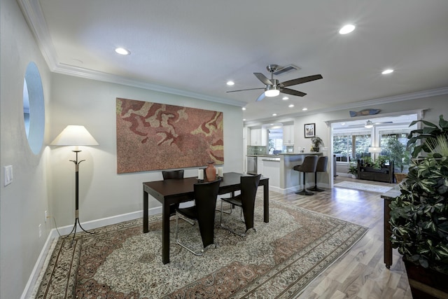 office with crown molding, light hardwood / wood-style flooring, and ceiling fan